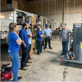 team standing around a demonstration