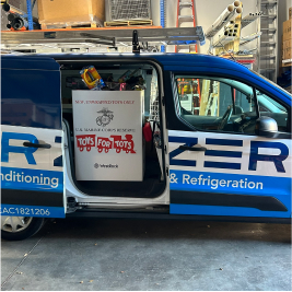 company vehicke with toys for tots box inside