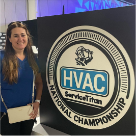 woman standing next to service titan HVAC national championship graphic