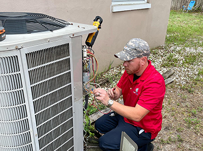 Technician working on AC unit